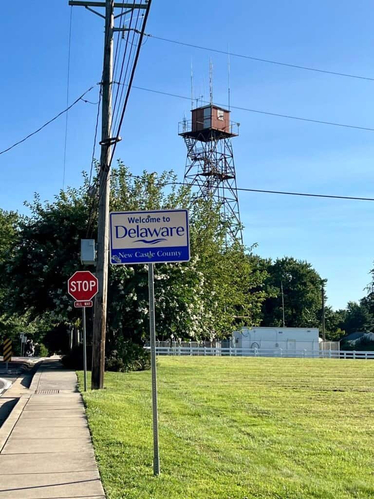 Western Union microwave radio tower near Ebright Azimuth with Welcome to Delaware sign in foreground