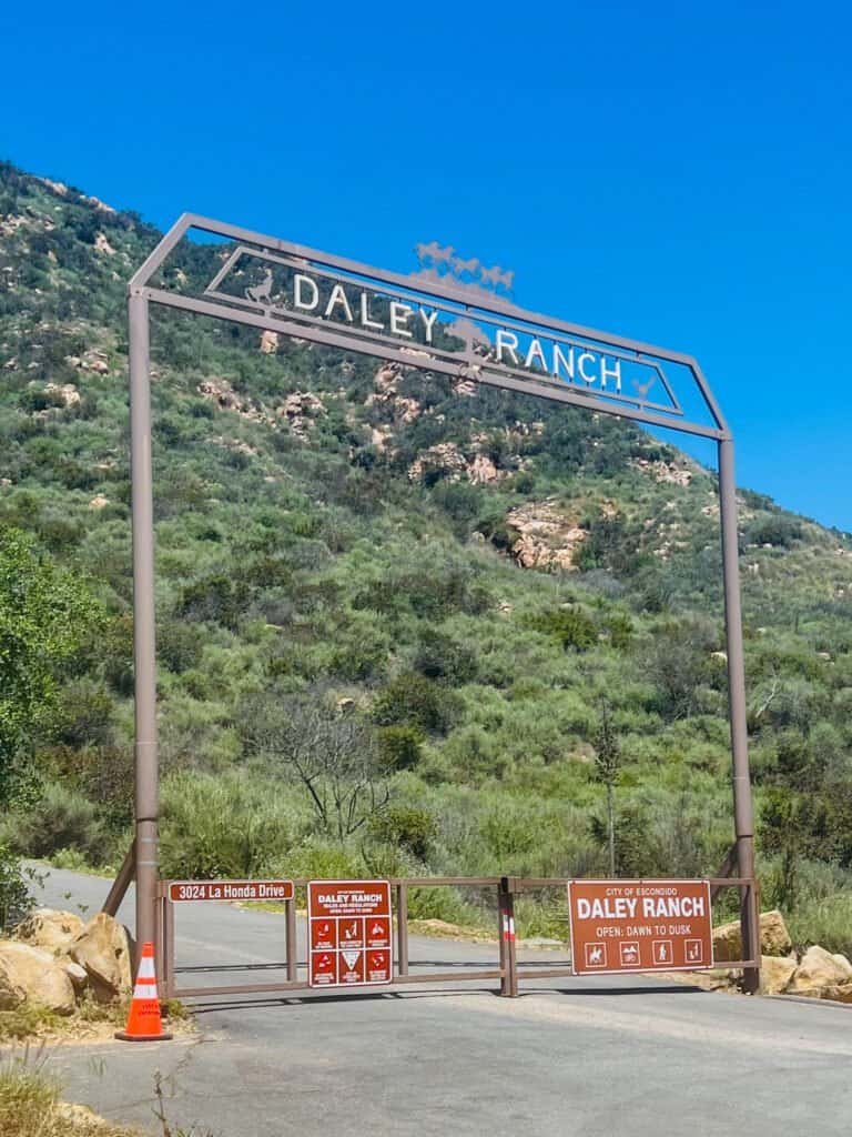 Daley Ranch entrance gate off La Honda Drive with hillside backdrop and posted park signage.