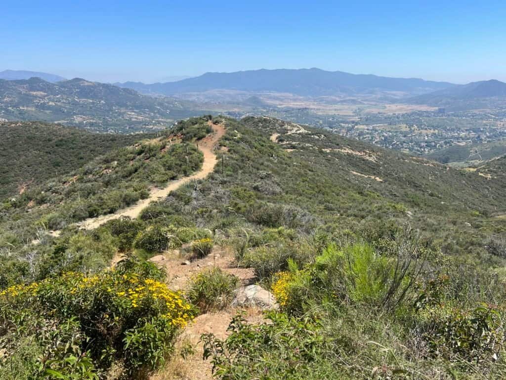 Ridgeline trail on McGinty Mountain with rolling hills and San Diego County stretching out below.
