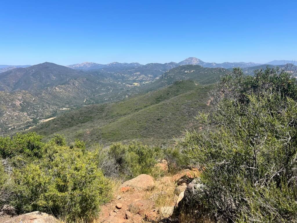 Wide mountain landscape view from the summit of McGinty Mountain with layered ridgelines stretching into the distance.