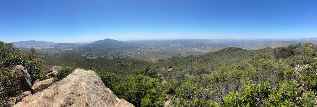 Another panoramic perspective from McGinty Mountain summit capturing expansive hills, valleys, and clear blue skies.