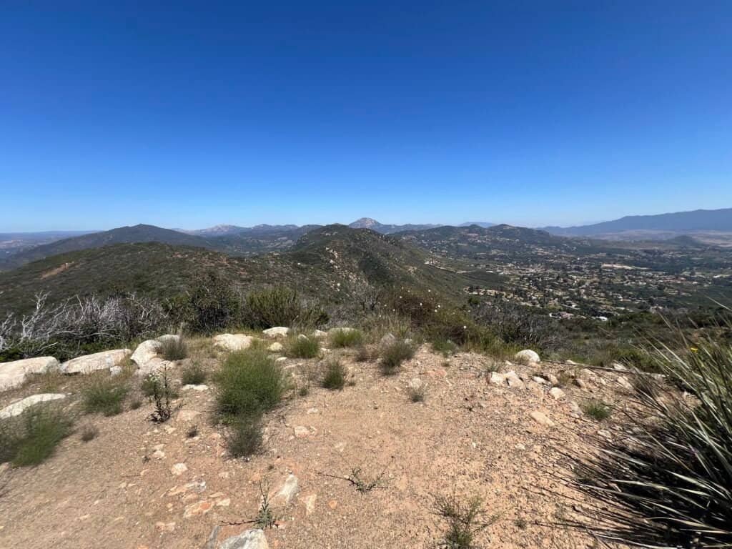 Wide view of rolling hills and valleys from the McGinty Mountain summit as the trail heads back down.