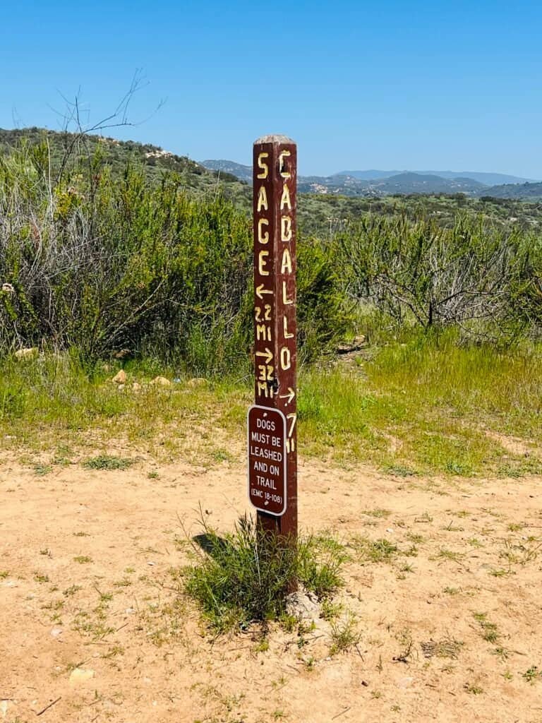 Wooden Sage Trail marker post at Daley Ranch showing distances and directions along the Sage Trail route.