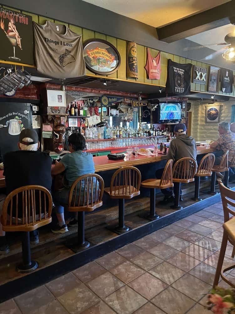 Bar area inside Hernandez Hideaway with patrons seated along the counter