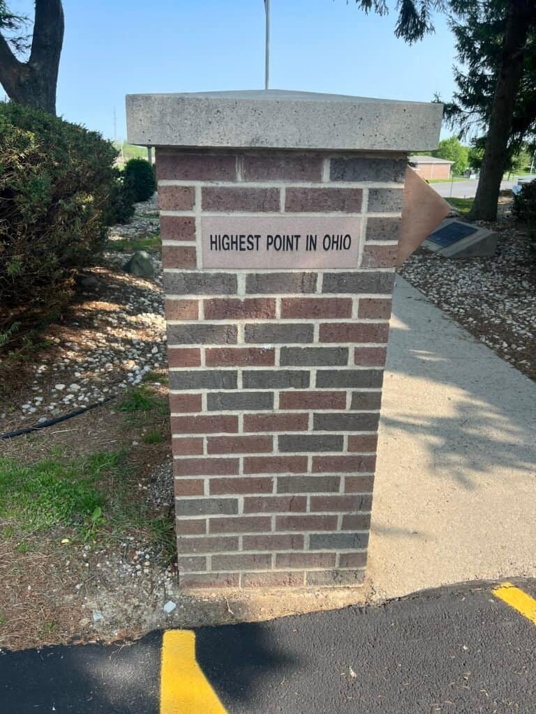 Brick marker near the parking lot indicating the highest point in Ohio at Campbell Hill