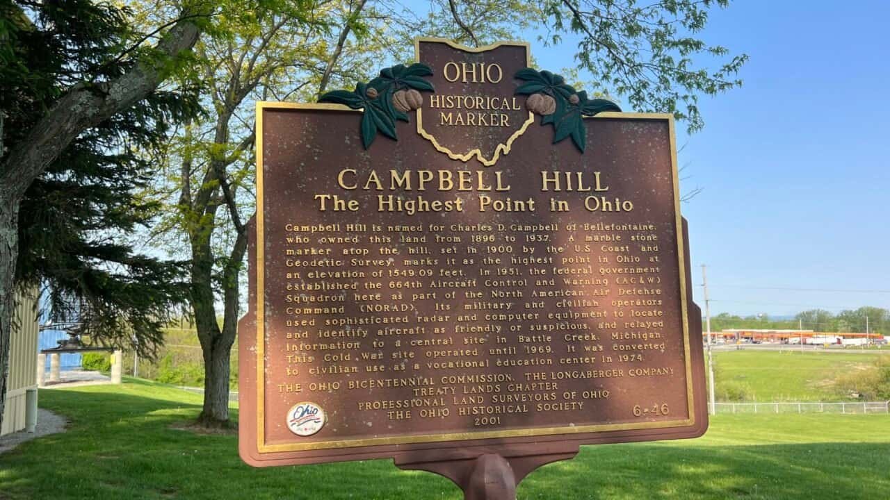 Ohio Historical Marker at Campbell Hill, the highest point in Ohio, located in Bellefontaine with trees and open grounds in the background