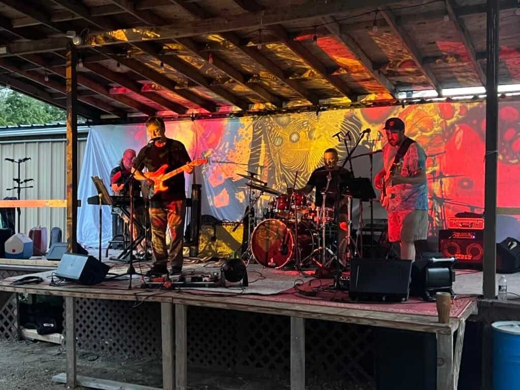 Grateful Dead tribute band playing on an outdoor campground stage at night
