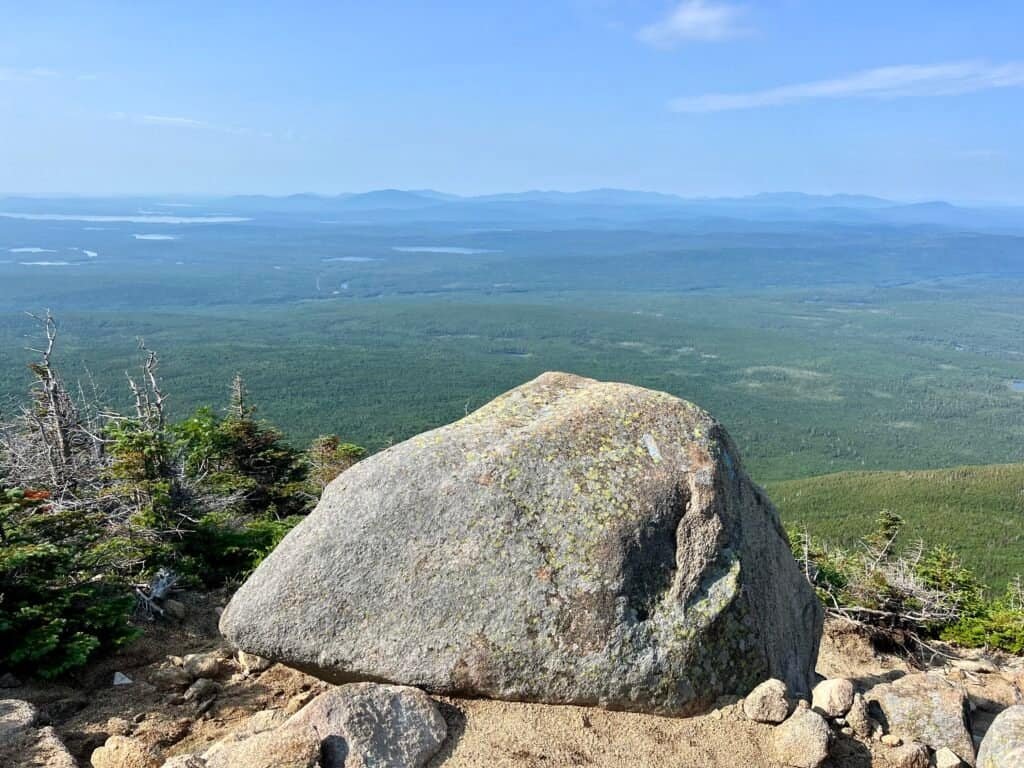 Large boulder overlook along the Abol Trail on Mount Katahdin with sweeping forest views
