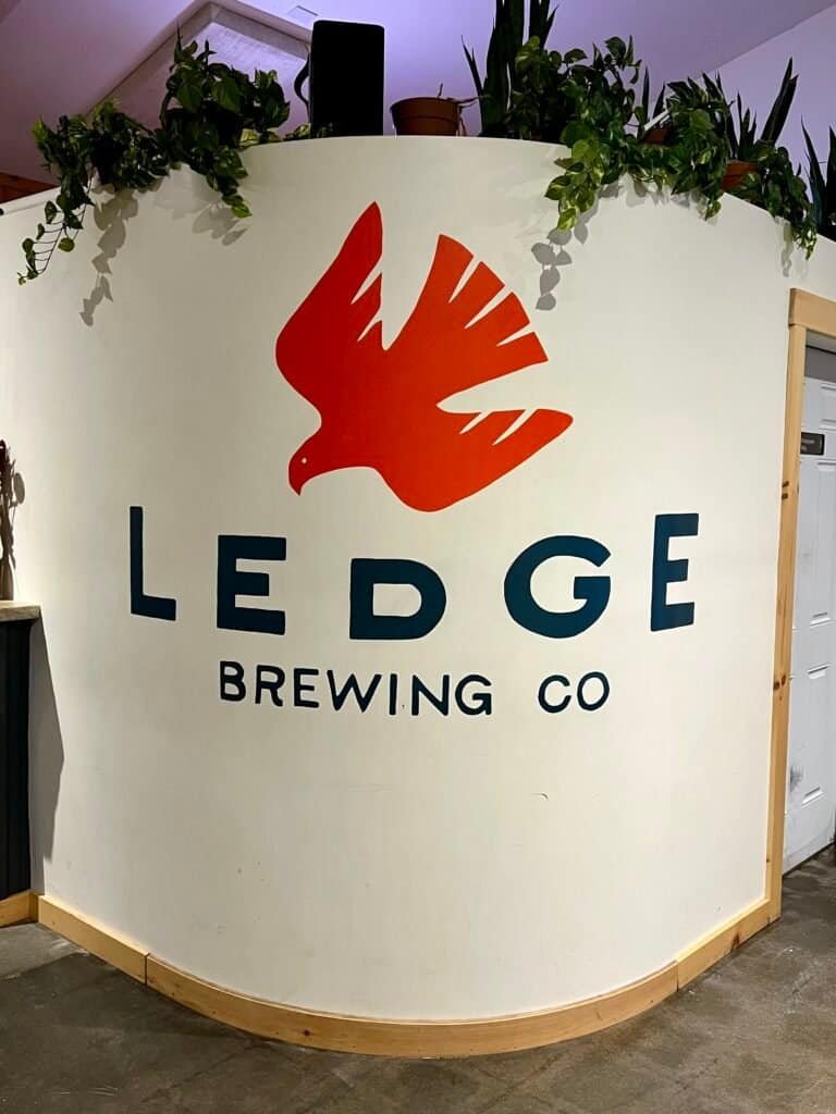 Interior wall sign with the Ledge Brewing Company logo inside the brewery in Intervale, New Hampshire.
