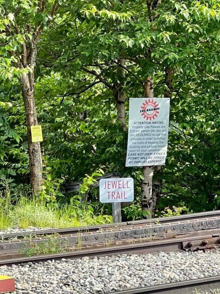 Jewell Trail sign beside the Mount Washington Cog Railway tracks near Marshfield Base Station in New Hampshire.