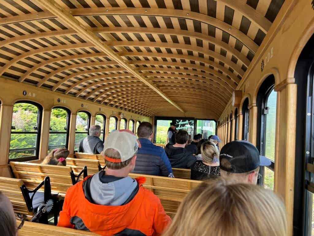 Passengers seated inside the Mount Washington Cog Railway train during the descent from the summit.