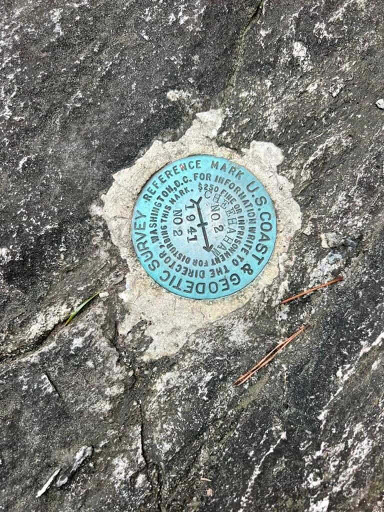 Close-up of U.S. Coast & Geodetic Survey reference marker embedded in rock at Cheaha Mountain.