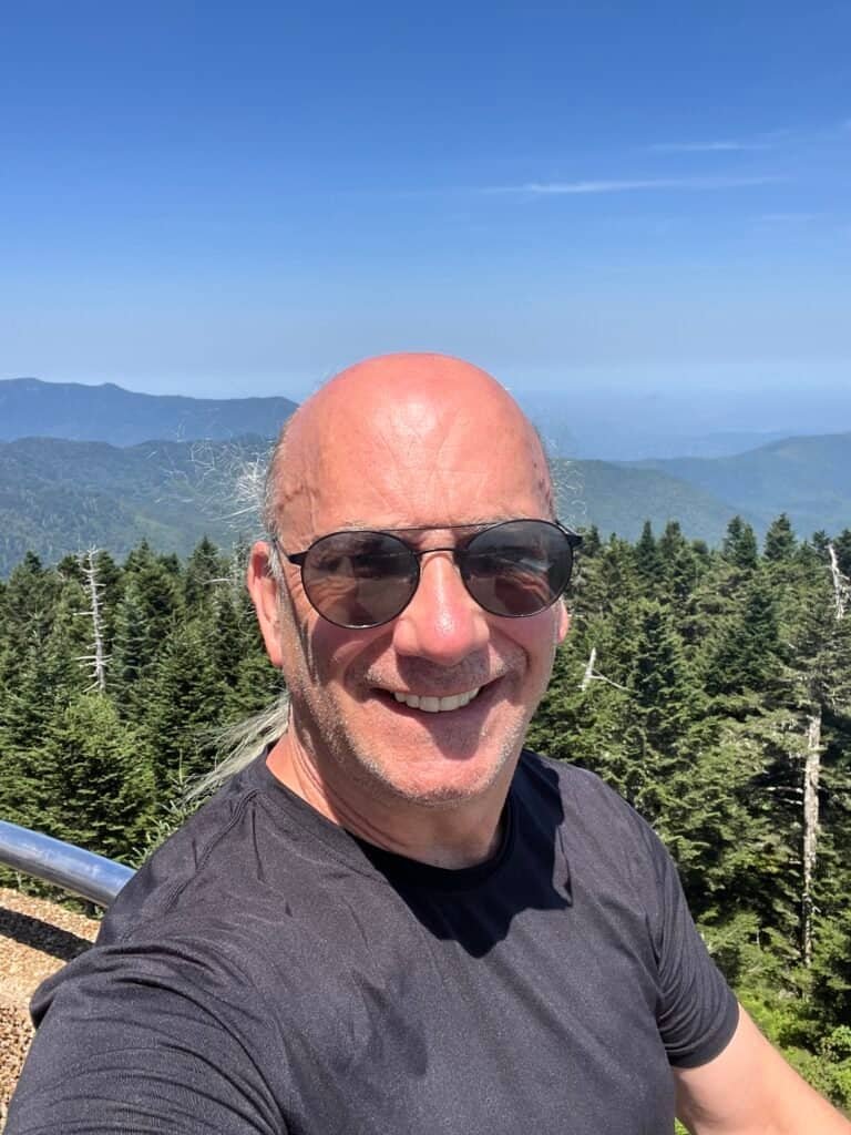 Hiker selfie with layered mountain views from the Clingmans Dome summit
