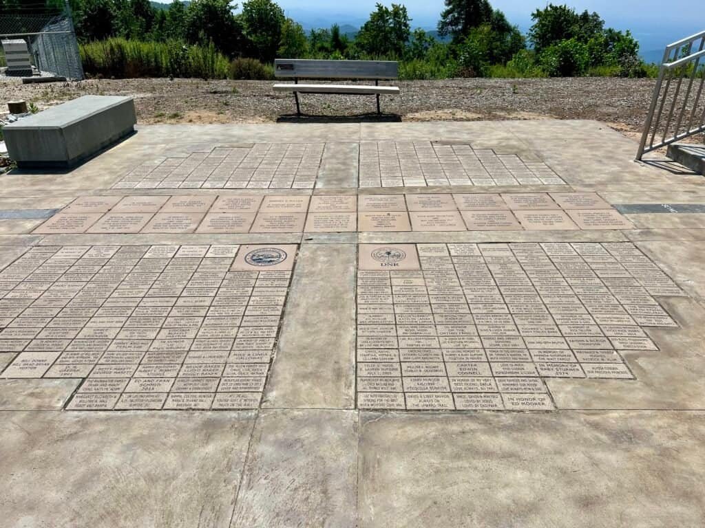 Donor bricks at the base of the Sassafras Mountain observation tower with the Highpointers Organization bench nearby