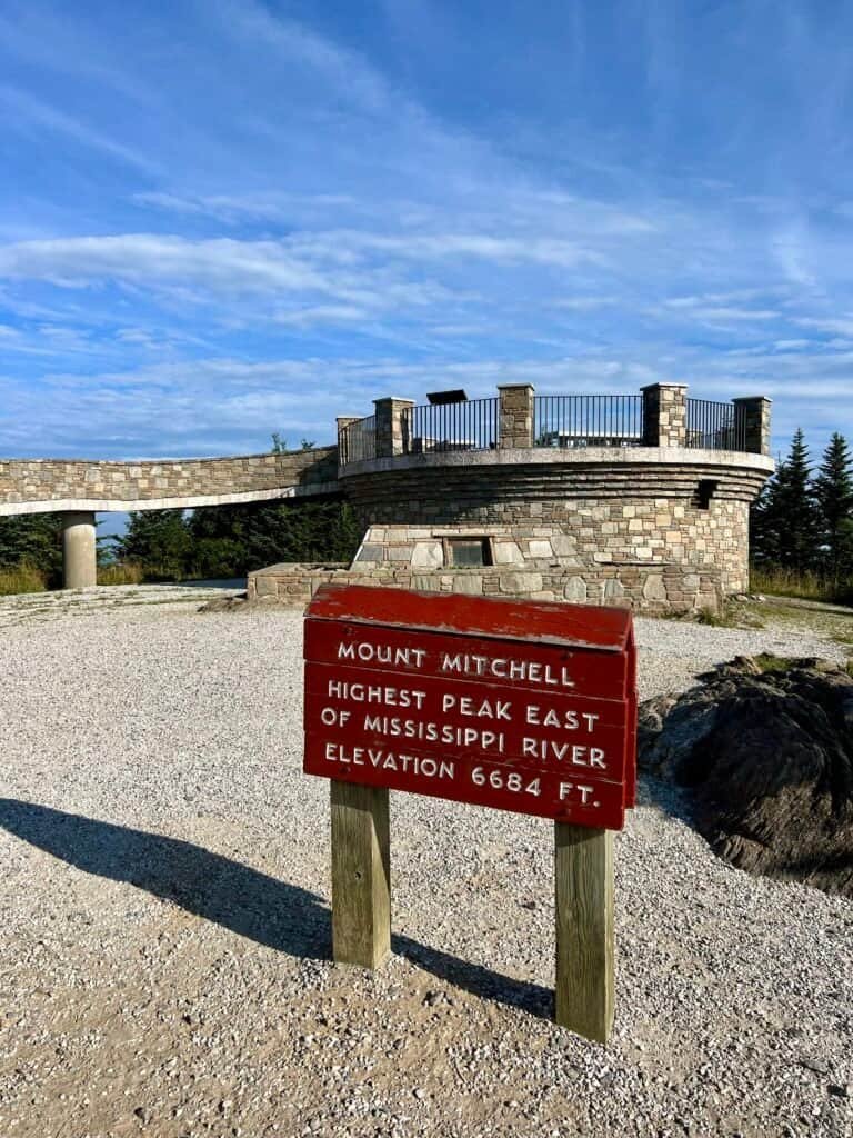 Mount Mitchell high point sign with the observation tower in the background