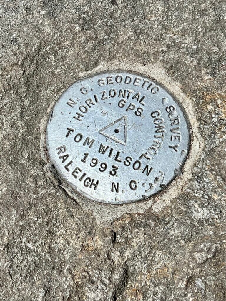 Geodetic survey marker embedded in rock at Big Tom summit