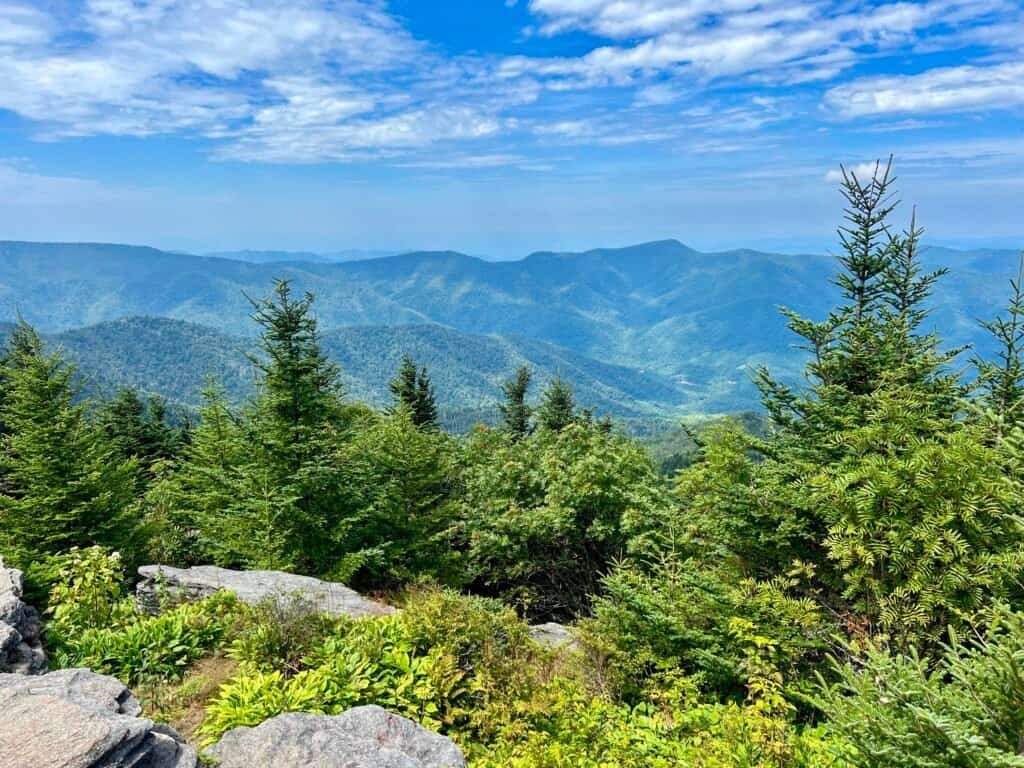 Panoramic mountain view from Mount Craig with layered Blue Ridge ridgelines and evergreen forest below