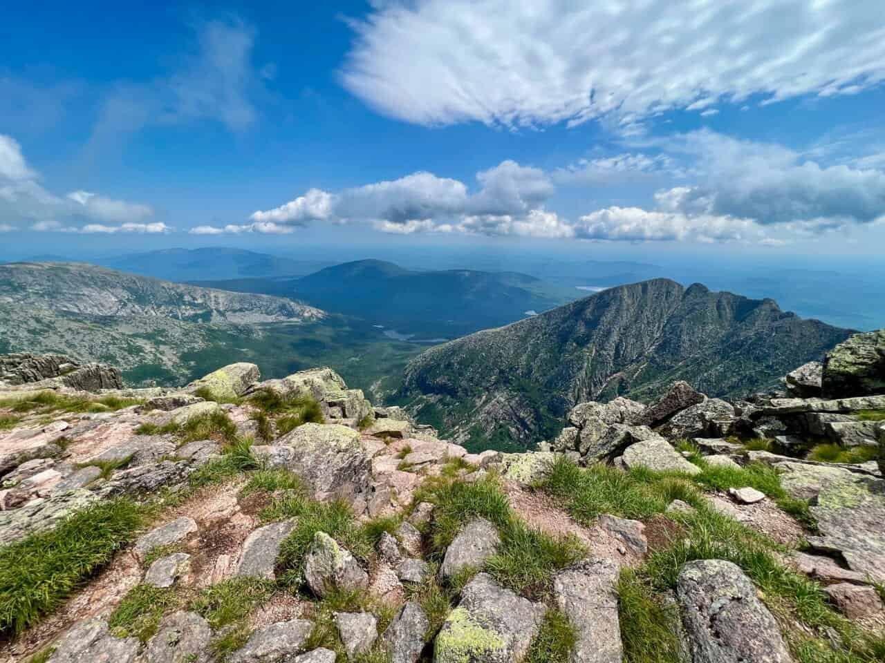 View from the summit of Mount Katahdin in Maine, overlooking rugged alpine peaks and distant lakes
