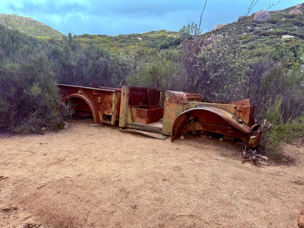Rusting vehicle remains known as “The Ruins” along the El Cajon Mountain trail near the upper plateau.