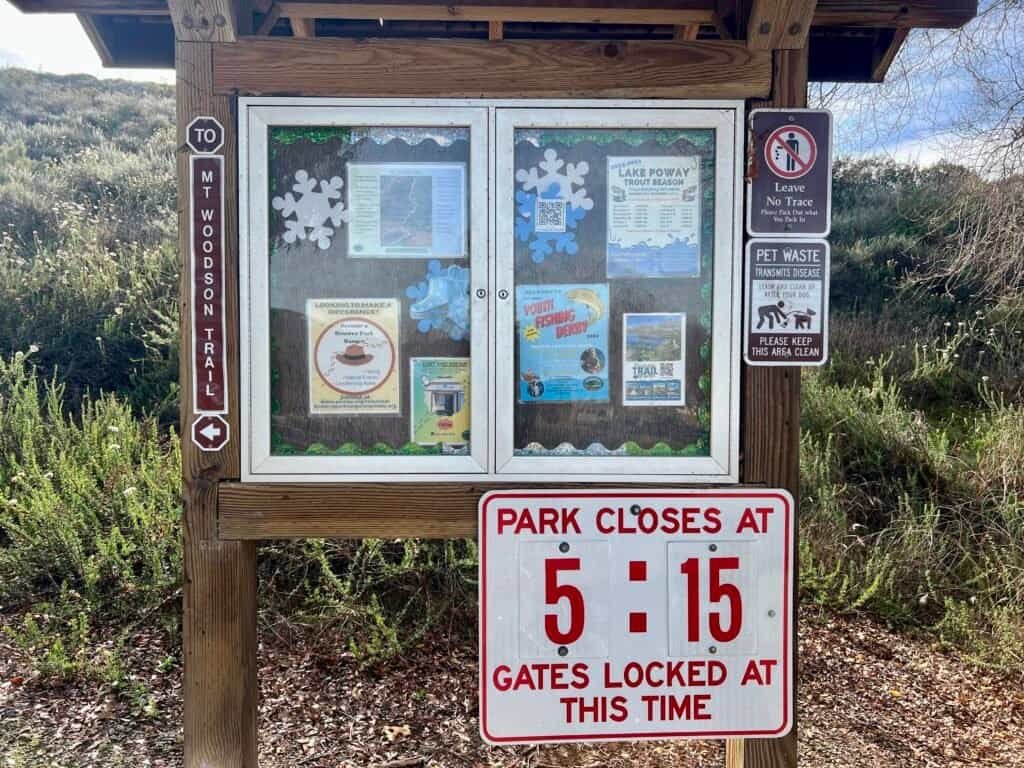 Park closing time sign showing gates locked at 5:15 PM at Lake Poway, California