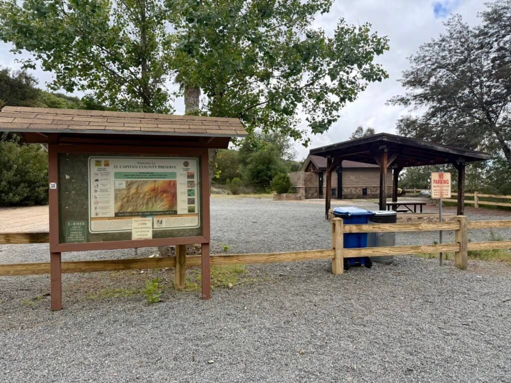 El Cajon Mountain trailhead with map kiosk, picnic table, and pit toilets at El Capitan County Preserve