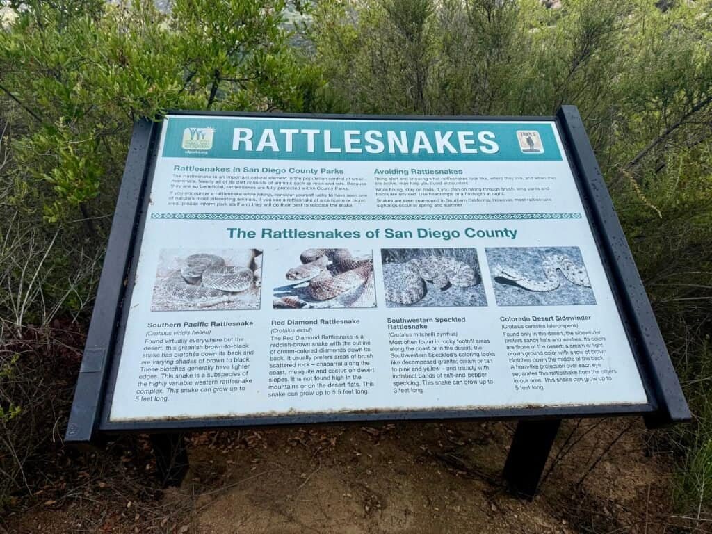Trail sign warning hikers about rattlesnakes commonly found in San Diego County parks.