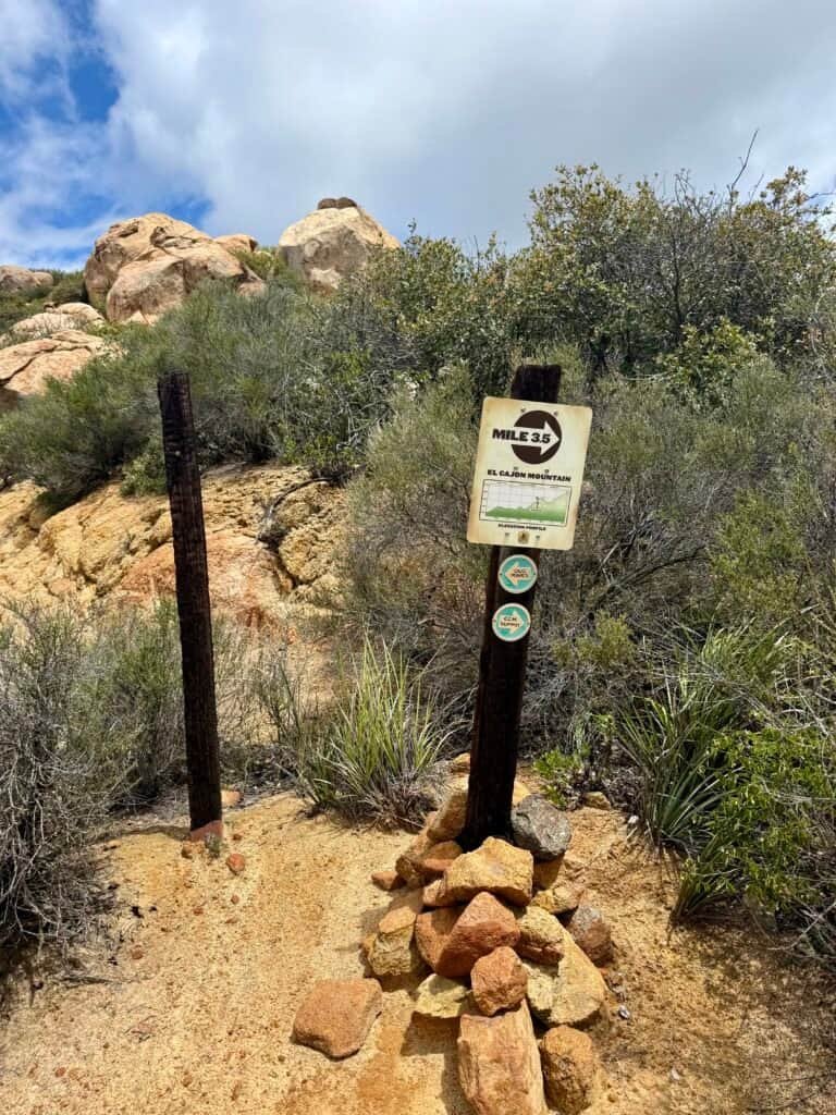 Mile 3.5 trail marker on El Cajon Mountain showing elevation profile and rocky terrain