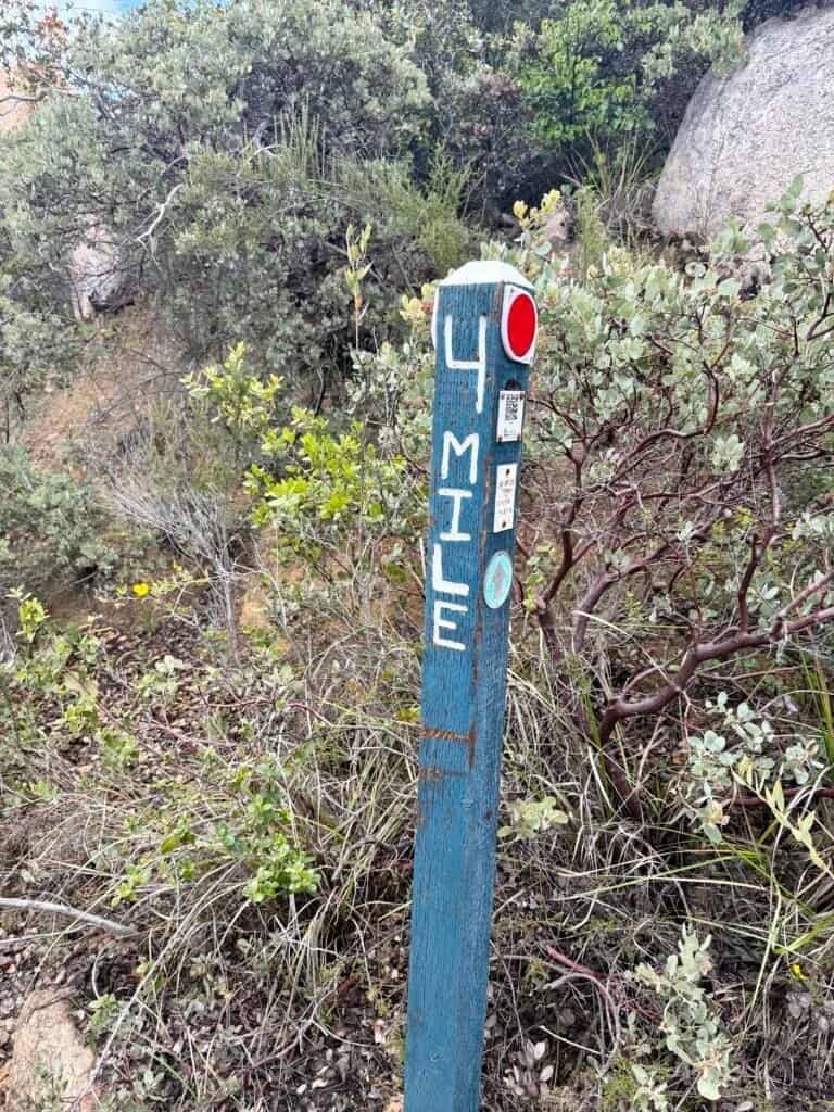 Hand-painted mile marker post along the El Cajon Mountain hiking trail