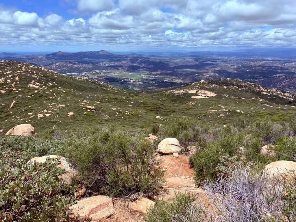 Panoramic view from El Cajon Mountain summit overlooking rolling hills and valleys in San Diego County.