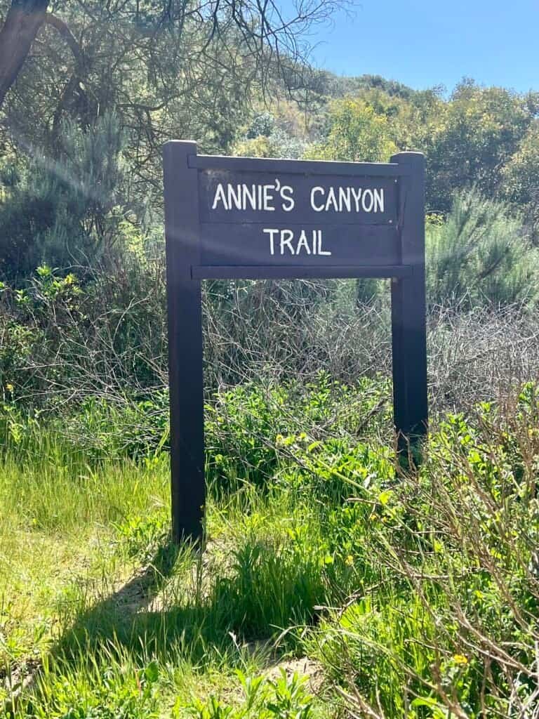 Wooden Annie’s Canyon Trail sign marking the entrance to the canyon route
