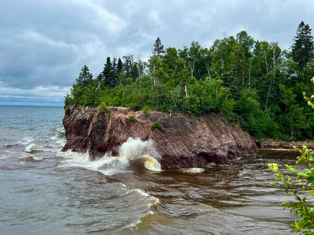 Waves crashing where the Baptism River meets Lake Superior at Tettegouche State Park.