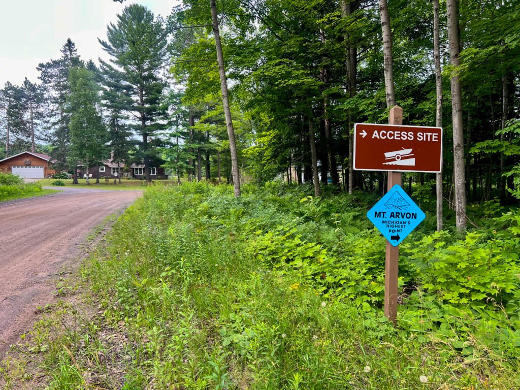 Access site sign and blue Mt. Arvon marker along a dirt logging road near Zion Lutheran Church in Michigan’s Upper Peninsula.