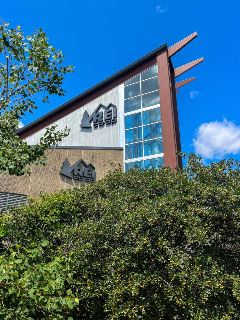 Exterior of REI Co-op flagship store building in Bloomington, Minnesota with modern architecture and large windows.