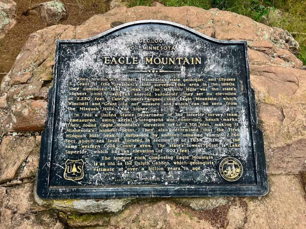 Eagle Mountain summit plaque detailing the geology and history of Minnesota’s highest point