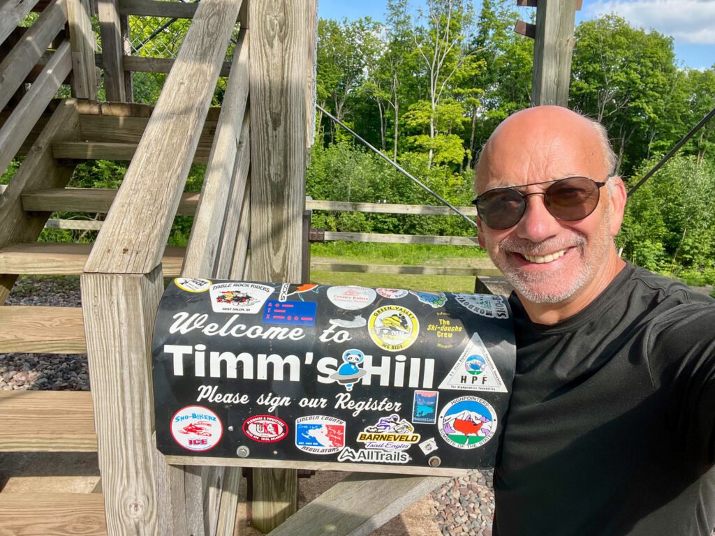 Summit selfie at Timms Hill mailbox register beneath the observation tower in Wisconsin.