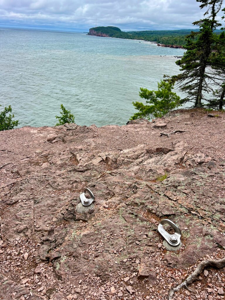 Rock climbing anchors at Shovel Point overlooking Lake Superior at Tettegouche State Park.
