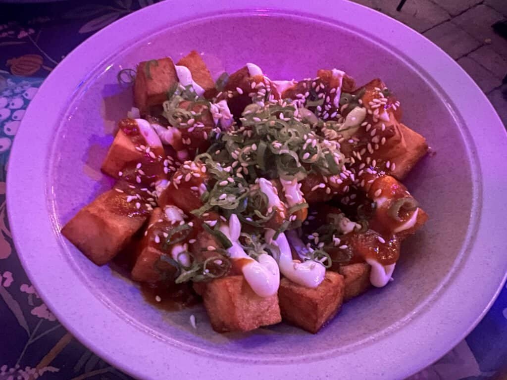 Crispy Manchurian potatoes tossed with sauce, sesame seeds, and scallions at Superkhana International