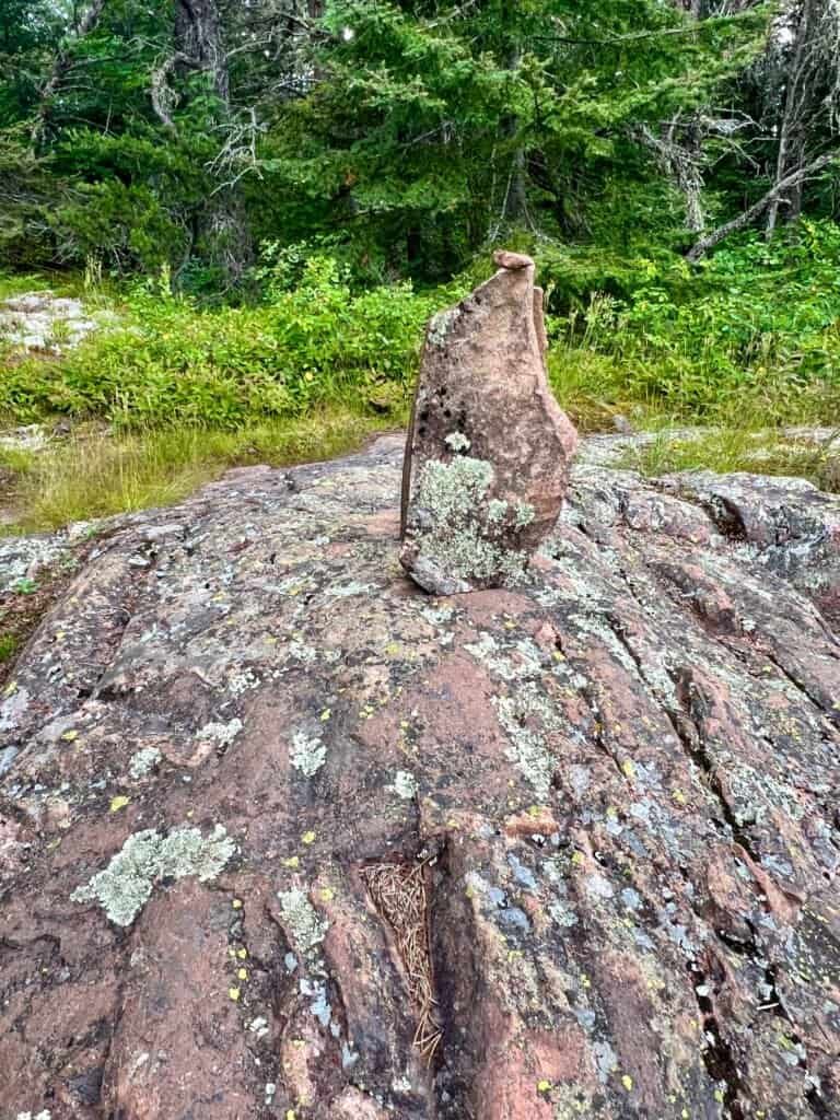Stone cairn placed on exposed bedrock marking the summit area of Eagle Mountain in northeastern Minnesota.