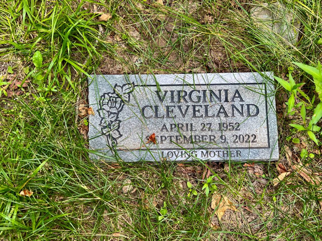 Memorial plaque for Virginia Cleveland at the Mount Arvon summit in Michigan’s Upper Peninsula forest.