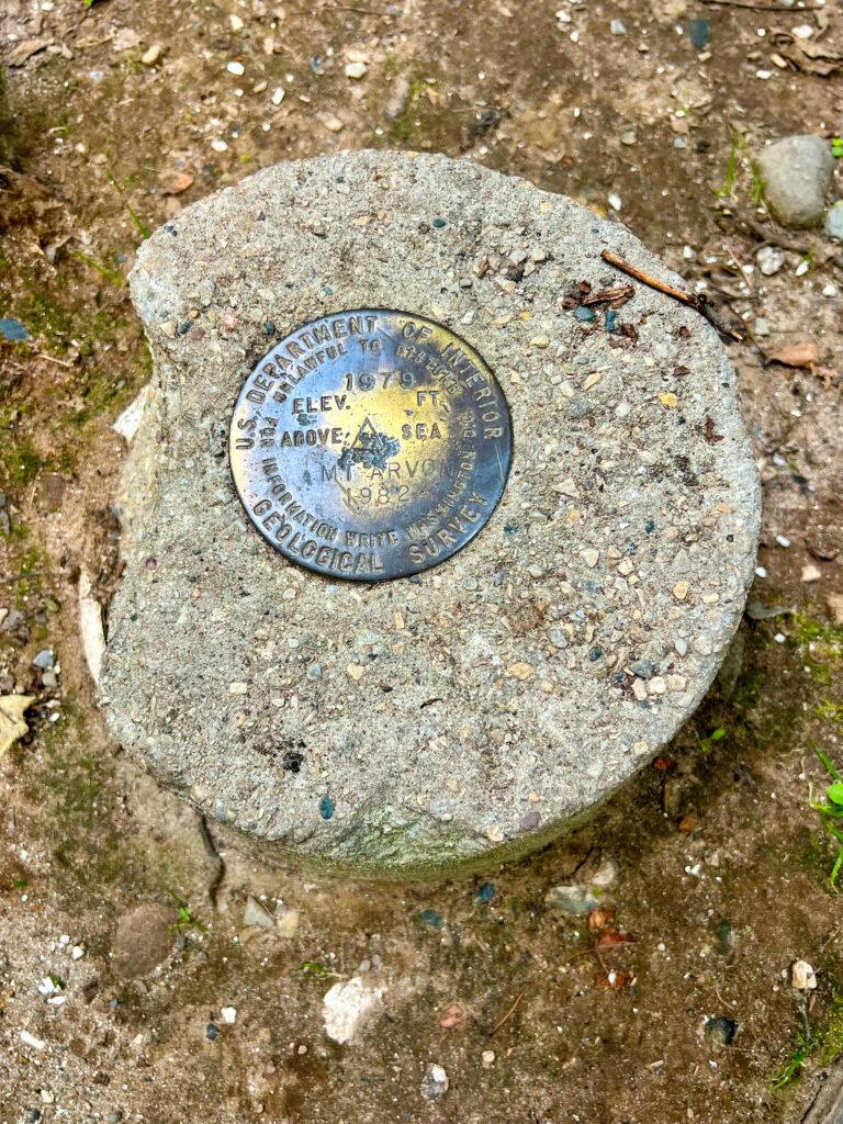 U.S. Geological Survey benchmark marker at the Mount Arvon summit showing elevation of 1,979 feet.