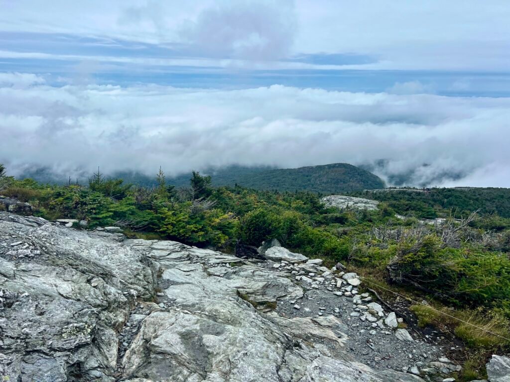 Cloud-filled valley view from the exposed Sunset Ridge Trail on Mount Mansfield.