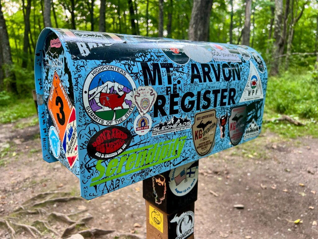 Sticker-covered Highpointers mailbox register at the Mount Arvon summit in Michigan’s Upper Peninsula.