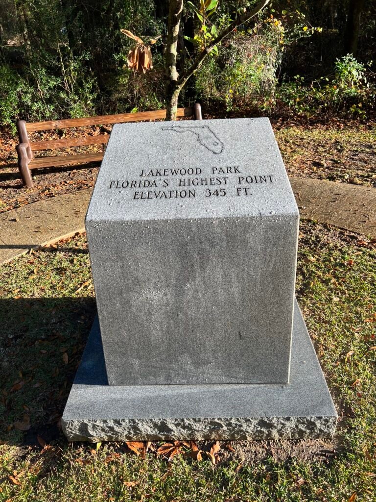 Granite marker at Britton Hill in Lakewood Park marking Florida’s highest point at 345 feet above sea level.