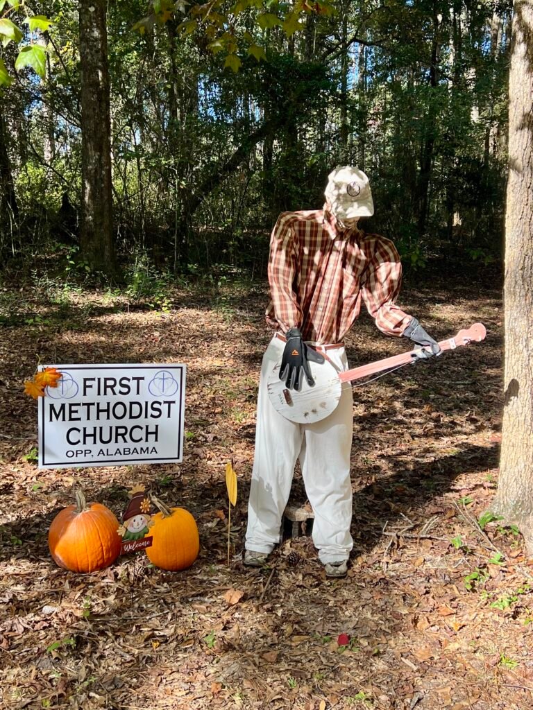 Banjo-playing scarecrow with pumpkins at Scarecrows in the Park in Opp, Alabama