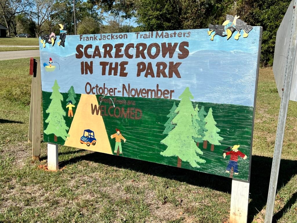 Colorful wooden sign for “Scarecrows in the Park” at Frank Jackson State Park in Opp, Alabama, held October through November.