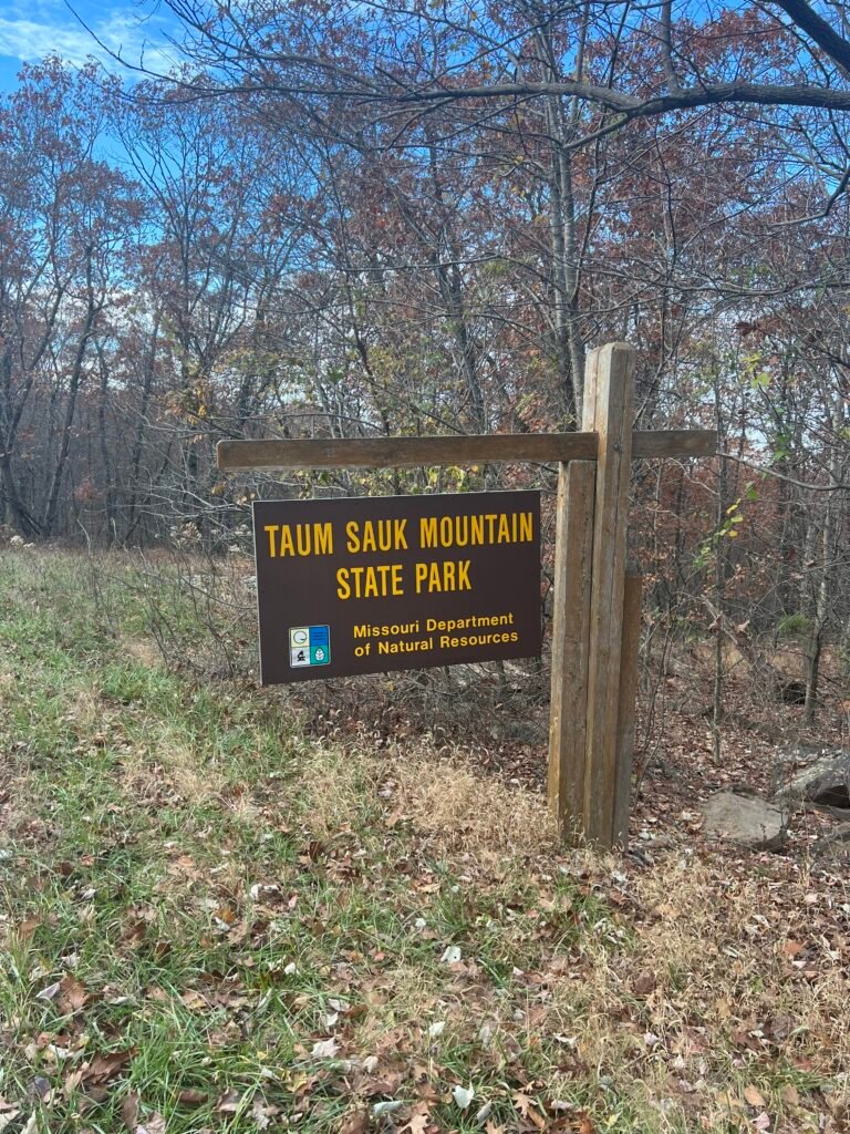 Brown sign reading “Taum Sauk Mountain State Park” at the entrance in the Missouri Ozarks.