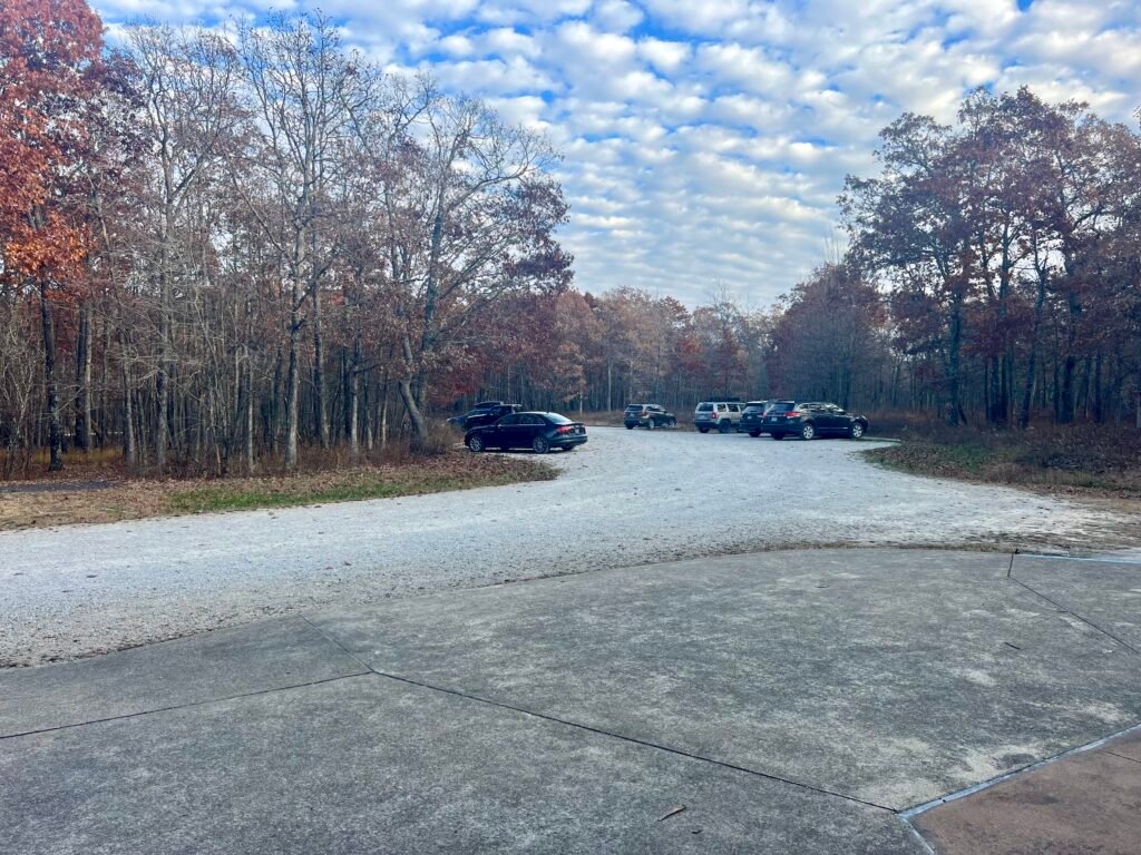 Gravel parking lot at Taum Sauk Mountain State Park surrounded by autumn forest in Missouri.