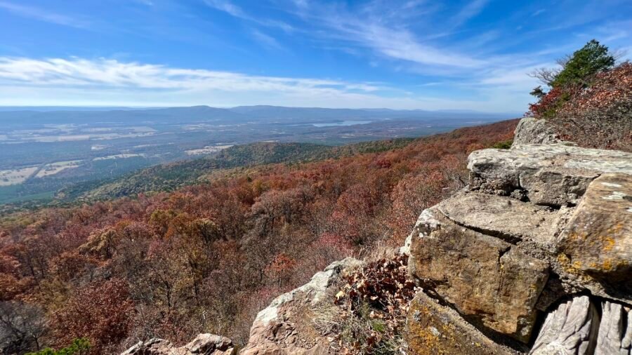 Panoramic view from Mount Magazine State Park overlooking the Arkansas River Valley with fall foliage and layered mountain ridges.