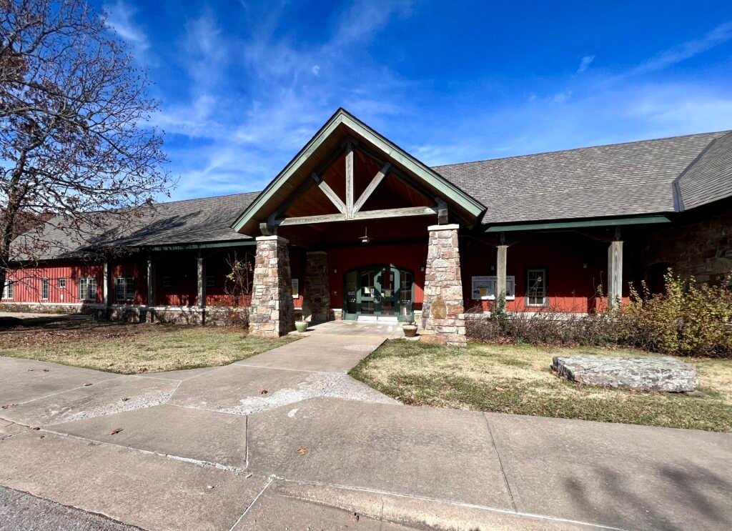 Mount Magazine State Park visitor center with stone columns and red exterior under blue sky