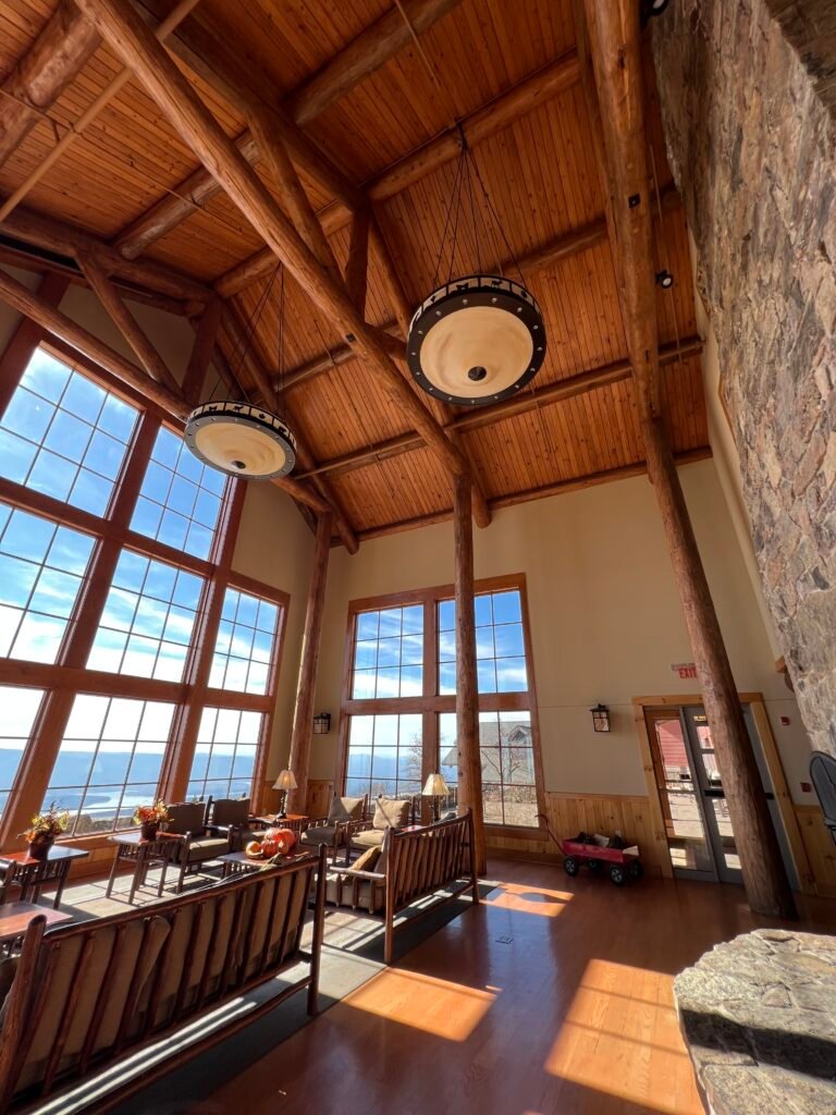 The Hearth Lobby at The Lodge with soaring wood beams, large windows, and valley views.